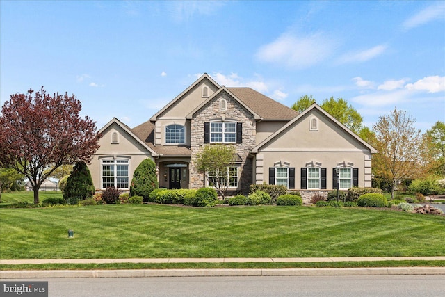 view of front of property with stone siding, stucco siding, and a front yard