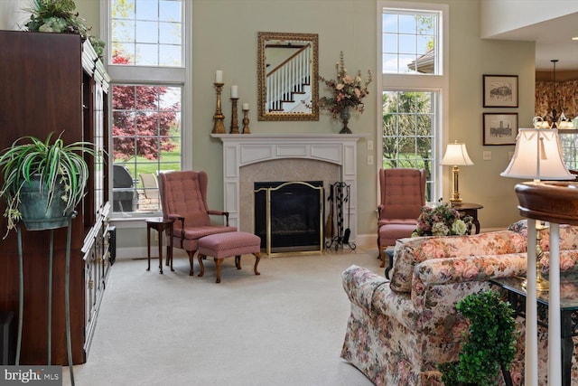 sitting room featuring carpet, a fireplace, and baseboards