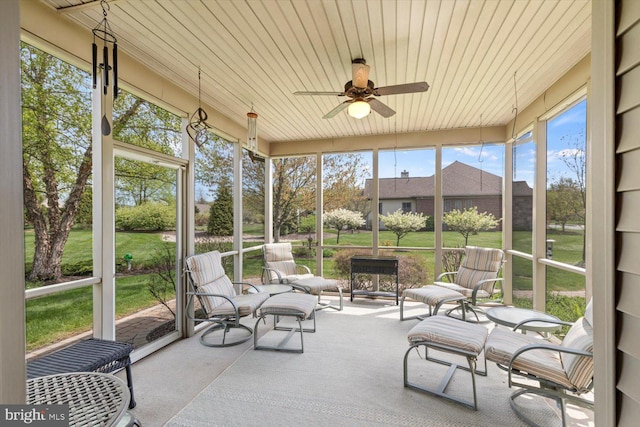 sunroom / solarium with a ceiling fan