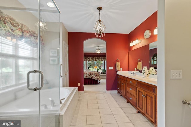 ensuite bathroom with a ceiling fan, double vanity, tile patterned floors, tiled tub, and an enclosed shower