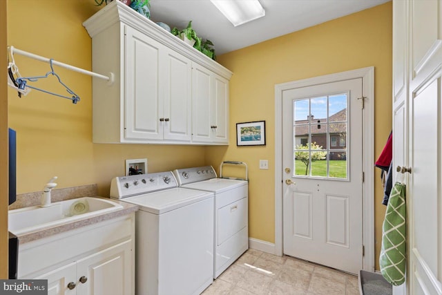 clothes washing area with cabinet space, washer and dryer, baseboards, and light tile patterned flooring