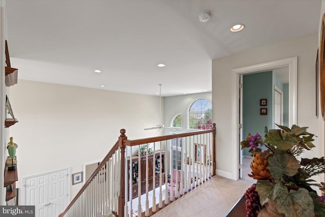 hall with light colored carpet, an upstairs landing, recessed lighting, and baseboards