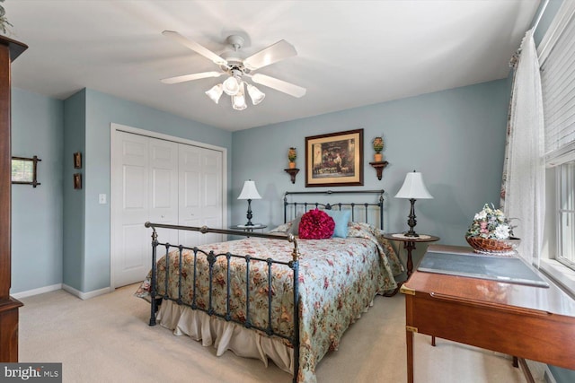 bedroom with carpet floors, a closet, baseboards, and ceiling fan