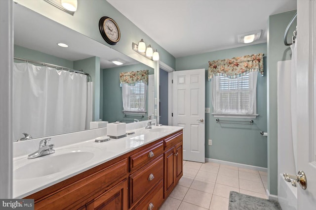 bathroom with tile patterned flooring, double vanity, and baseboards