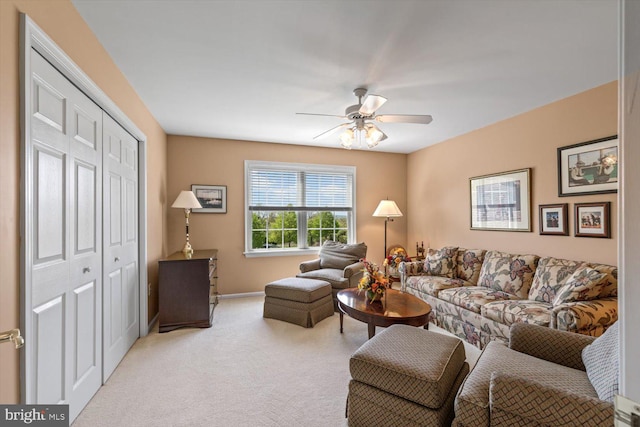 living room featuring carpet floors, ceiling fan, and baseboards