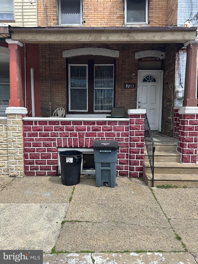 view of exterior entry with brick siding