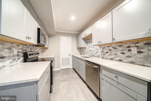 8318 Kingsgate Rd Unit 537, Springfield, VA 22152 - kitchen featuring stainless steel appliances, a sink, crown molding, baseboards, and decorative backsplash