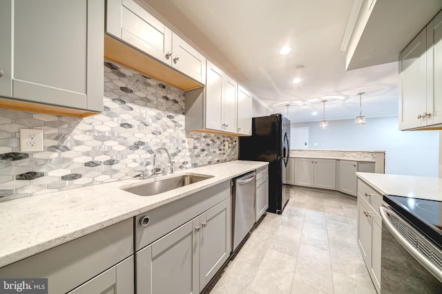 8318 Kingsgate Rd Unit 537, Springfield, VA 22152 - kitchen featuring stainless steel appliances, a sink, decorative backsplash, light stone counters, and pendant lighting