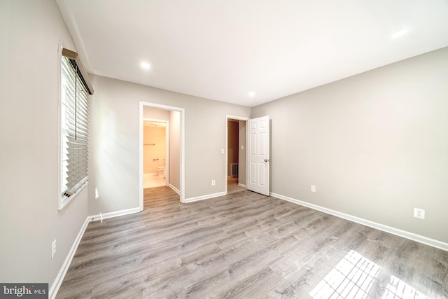 8318 Kingsgate Rd Unit 537, Springfield, VA 22152 - unfurnished bedroom with baseboards, light wood-style flooring, ensuite bath, and recessed lighting