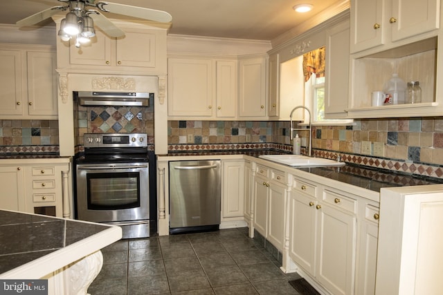 1158 Custer Dr, Auburn, PA 17922 - kitchen with stainless steel appliances, a sink, dark countertops, under cabinet range hood, and crown molding