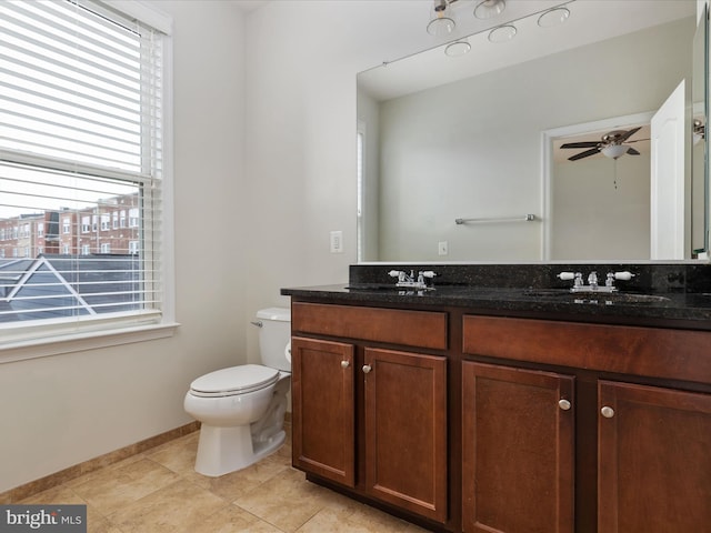 9411 Zebedee St, Manassas, VA 20110 - bathroom with double vanity, toilet, ceiling fan, tile patterned floors, and baseboards
