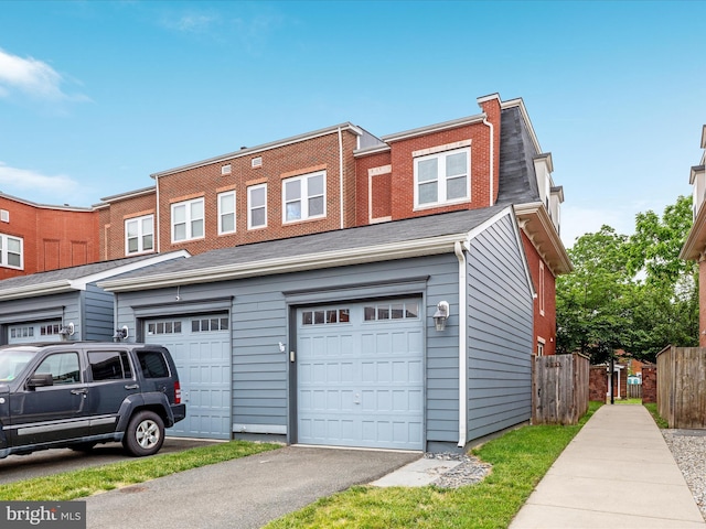 9411 Zebedee St, Manassas, VA 20110 - view of property featuring a garage and asphalt driveway