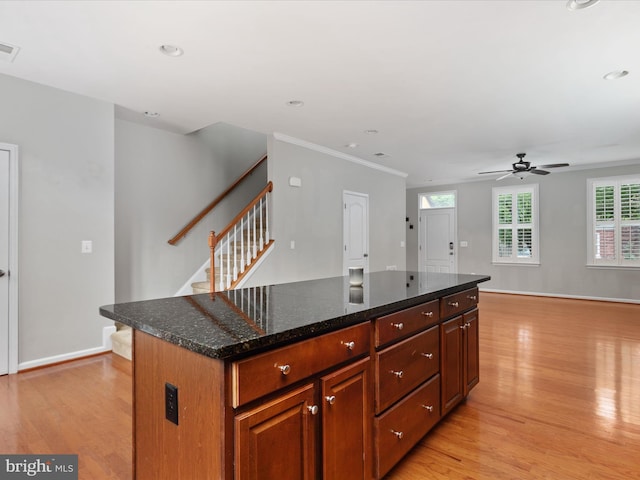 9411 Zebedee St, Manassas, VA 20110 - kitchen featuring light wood-style flooring, a ceiling fan, open floor plan, crown molding, and recessed lighting