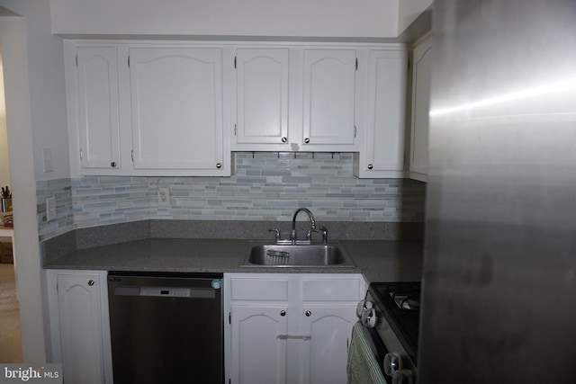 kitchen with dishwashing machine, stainless steel refrigerator, a sink, range with gas stovetop, and white cabinetry