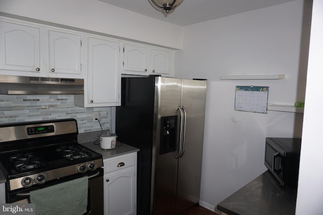 kitchen featuring appliances with stainless steel finishes, under cabinet range hood, tasteful backsplash, and white cabinetry