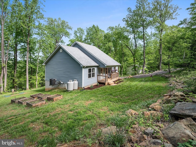 433 Tulip Poplar Dr, Linden, VA 22642 - view of property exterior featuring a garden, a lawn, a deck, and central AC unit