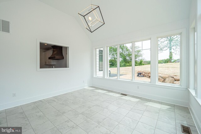 unfurnished sunroom with lofted ceiling and a chandelier