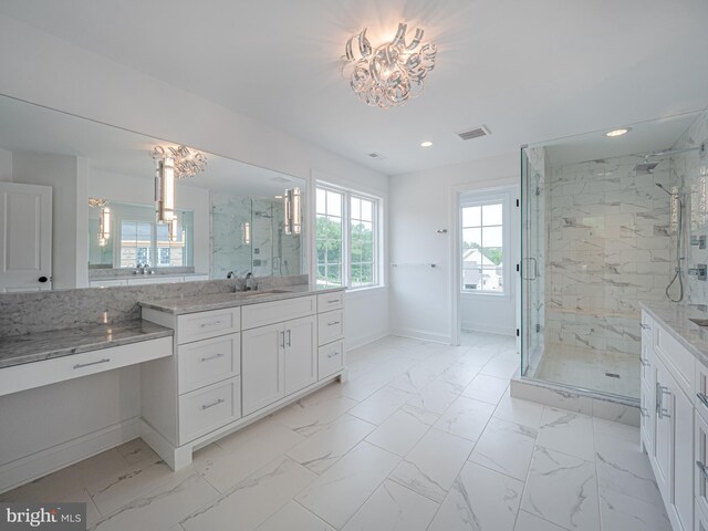 bathroom featuring marble look tiles, recessed lighting, a marble finish shower, and vanity