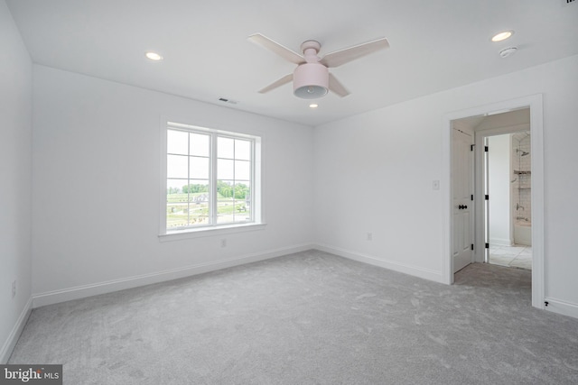 spare room featuring carpet, a ceiling fan, recessed lighting, baseboards, and a smoke detector