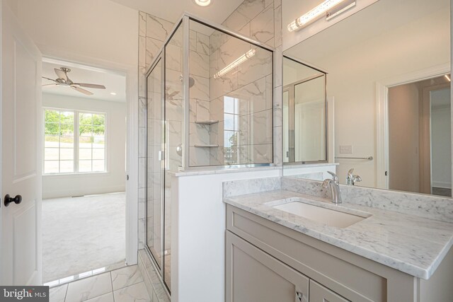 full bath featuring marble look tile flooring, a stall shower, vanity, a ceiling fan, and recessed lighting