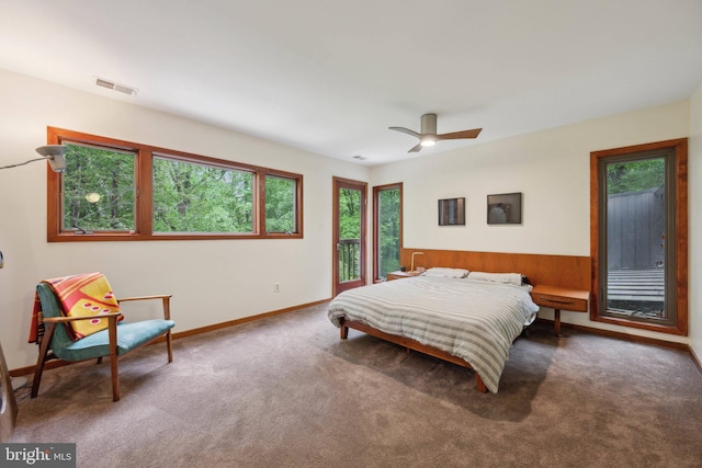 carpeted bedroom with multiple windows, baseboards, access to exterior, and a ceiling fan