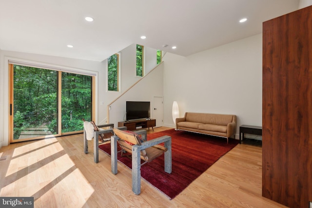 living area featuring light wood-style flooring and recessed lighting