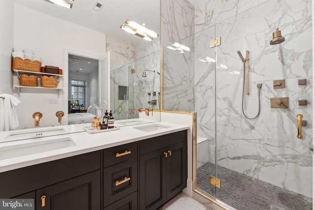 full bathroom with marble finish flooring, a marble finish shower, double vanity, and ensuite bath