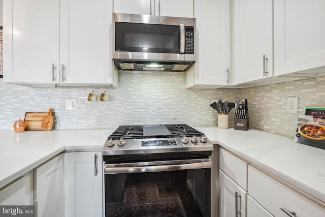 528 Kennedy St NW Unit 502, Washington, DC 20011 - kitchen featuring stainless steel appliances, white cabinets, and backsplash