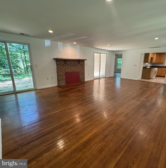 8888 Harmony Rd, Denton, MD 21629 - unfurnished living room with dark wood-style floors, baseboards, recessed lighting, and a fireplace