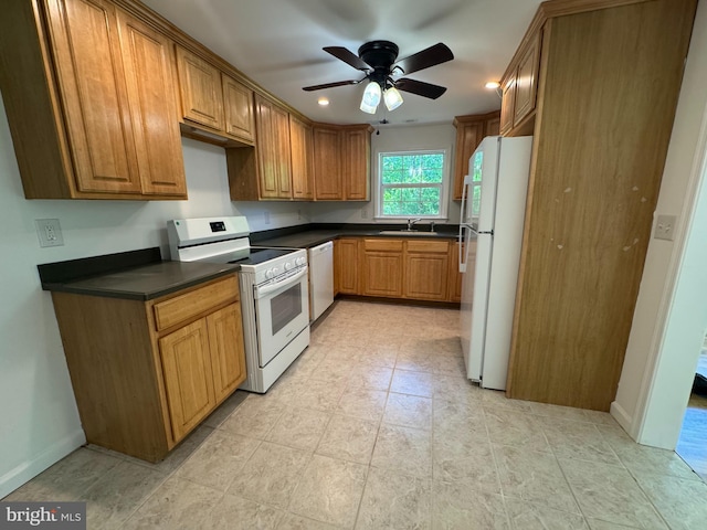 8888 Harmony Rd, Denton, MD 21629 - kitchen with white appliances, dark countertops, ceiling fan, brown cabinetry, and recessed lighting