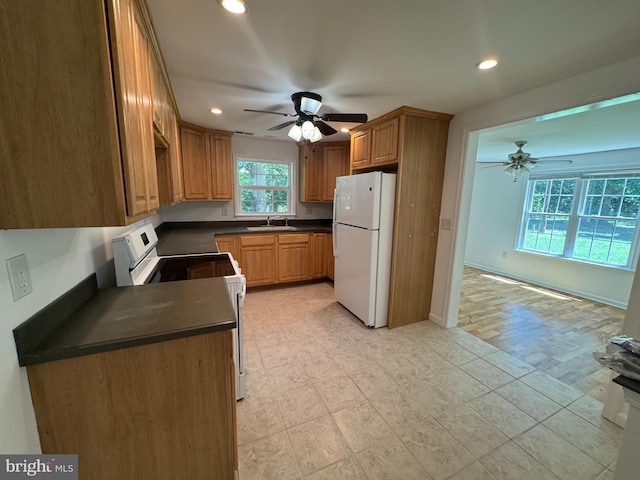 8888 Harmony Rd, Denton, MD 21629 - kitchen with white appliances, a ceiling fan, dark countertops, a sink, and recessed lighting