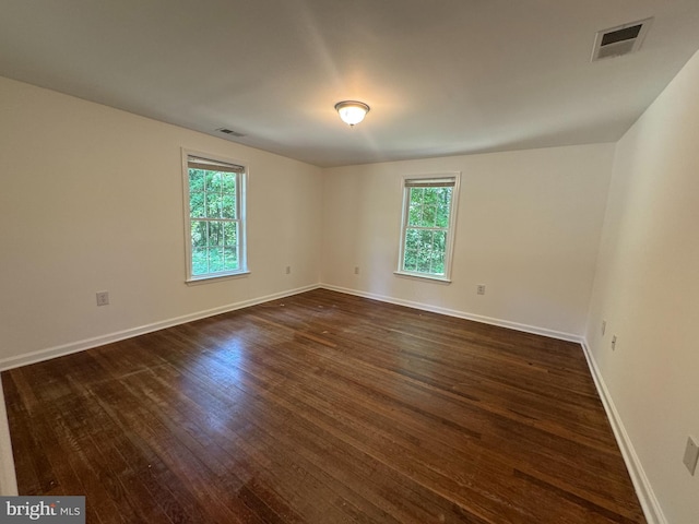 8888 Harmony Rd, Denton, MD 21629 - unfurnished room with plenty of natural light, dark wood finished floors, and baseboards