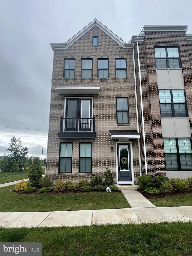 42089 Shining Star Sq, Brambleton, VA 20148 - view of property featuring brick siding and a balcony
