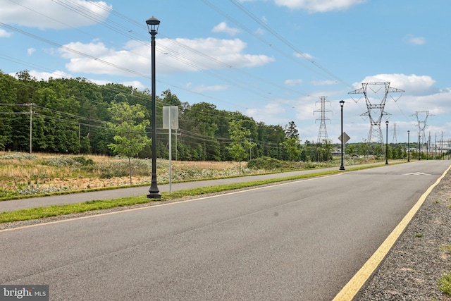 42089 Shining Star Sq, Brambleton, VA 20148 - view of asphalt road featuring sidewalks, street lights, and traffic signs