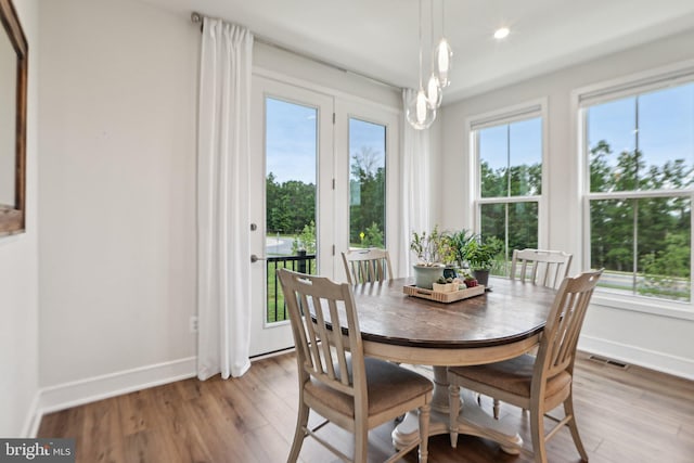 42089 Shining Star Sq, Brambleton, VA 20148 - dining area featuring baseboards, wood finished floors, and recessed lighting