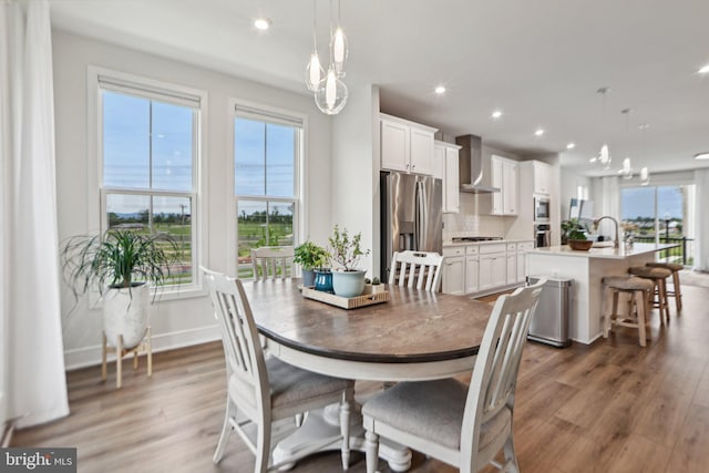 42089 Shining Star Sq, Brambleton, VA 20148 - dining space with plenty of natural light, wood finished floors, recessed lighting, and baseboards