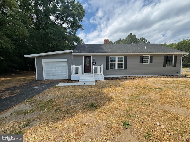 581 Milford Neck Rd, Milford, DE 19963 - single story home with an attached garage, a chimney, and asphalt driveway