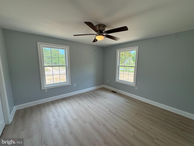 581 Milford Neck Rd, Milford, DE 19963 - unfurnished room featuring healthy amount of natural light, wood finished floors, ceiling fan, and baseboards