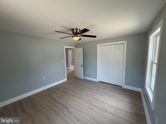 581 Milford Neck Rd, Milford, DE 19963 - unfurnished bedroom with wood finished floors, baseboards, a closet, and a ceiling fan