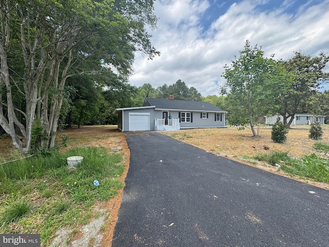 581 Milford Neck Rd, Milford, DE 19963 - view of front of home with a garage, driveway, and a chimney