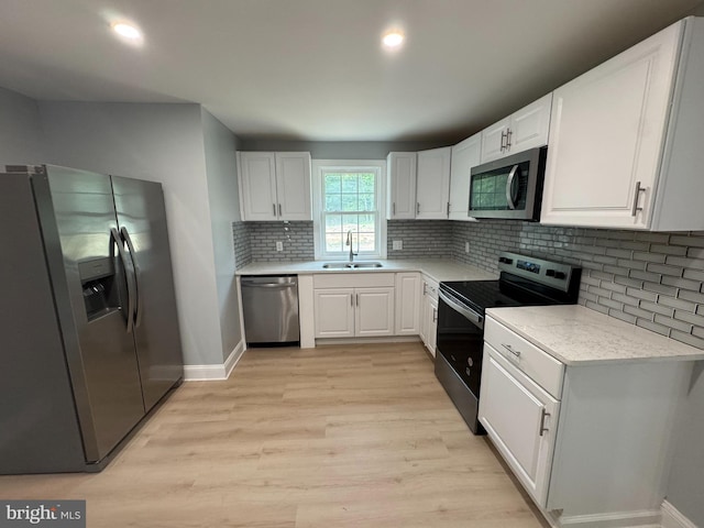 581 Milford Neck Rd, Milford, DE 19963 - kitchen featuring appliances with stainless steel finishes, light wood-style flooring, light countertops, white cabinetry, and recessed lighting