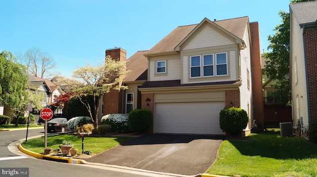 7501 Silver Maple Ln, Falls Church, VA 22042 - view of front of house with brick siding, a front lawn, an attached garage, and central AC
