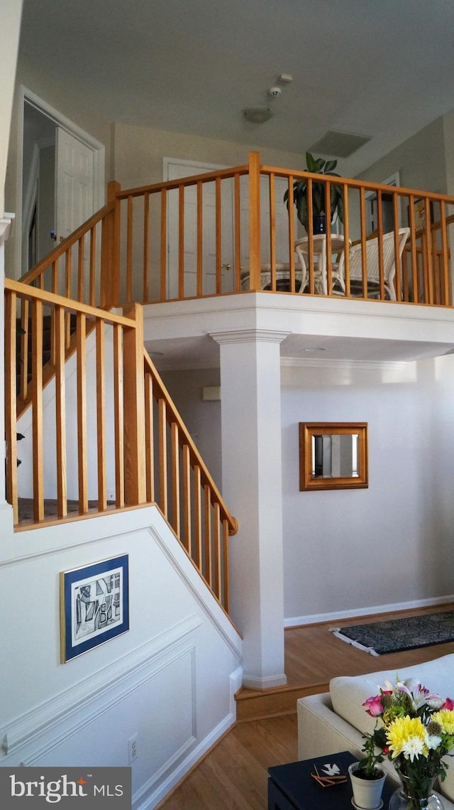 7501 Silver Maple Ln, Falls Church, VA 22042 - stairs featuring wood finished floors, a towering ceiling, and baseboards