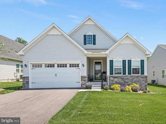 view of front of house featuring stone siding, asphalt driveway, a front yard, and cooling unit