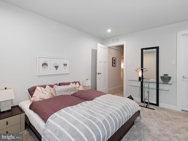 carpeted bedroom featuring baseboards and recessed lighting