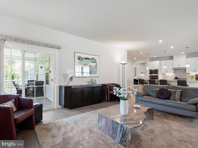 living area featuring light wood-style floors and recessed lighting