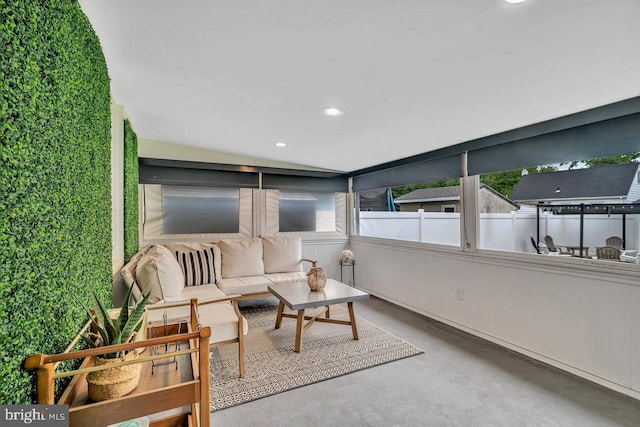 sunroom with finished concrete floors, an outdoor hangout area, and recessed lighting