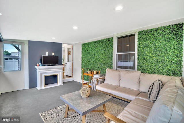 carpeted living room with recessed lighting and a fireplace
