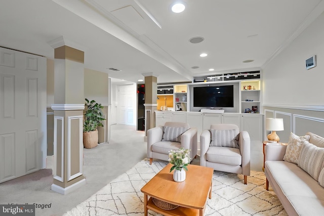 living room featuring crown molding, a decorative wall, recessed lighting, and wainscoting