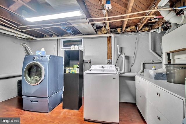 laundry area featuring washing machine and dryer and wood finished floors